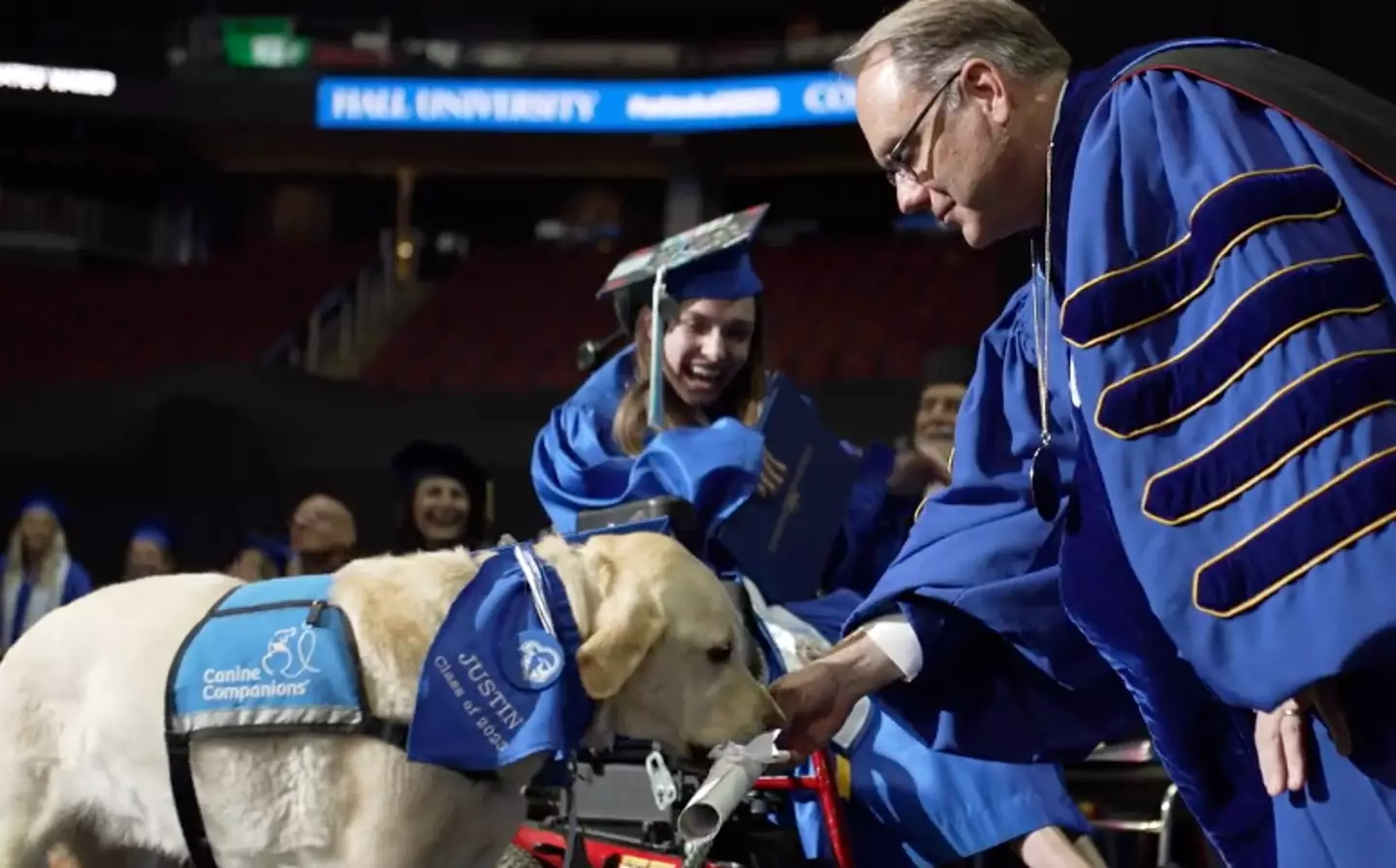 Justin collected his diploma alongside his owner Grace Mariani.