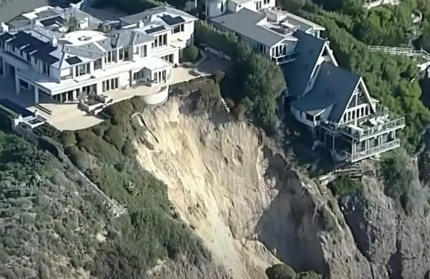 One house looks like it's almost dangling off the cliff slightly.