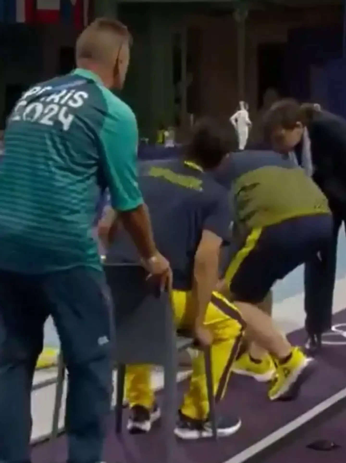 A medic sat down in a chair meant for the fencer (BBC)