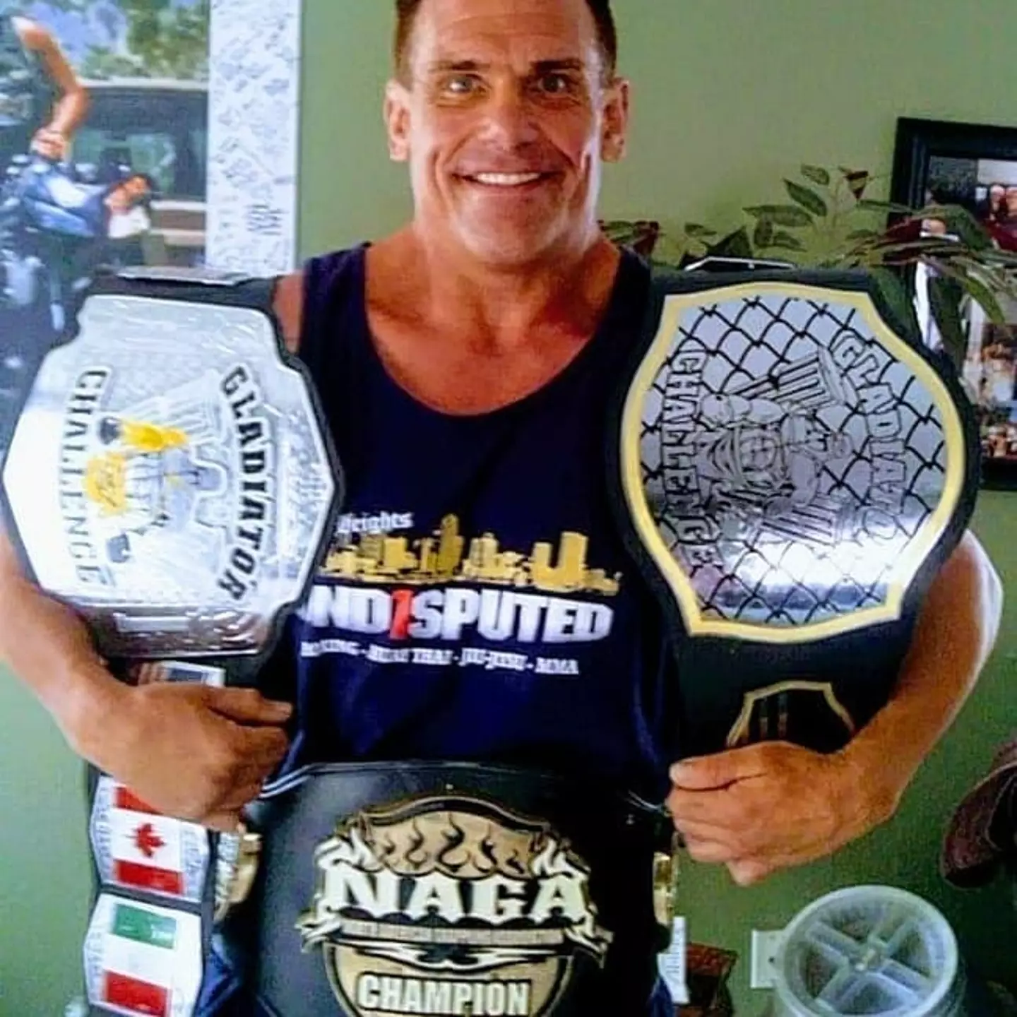 Brink with some of his winning belts for his MMA clashes.