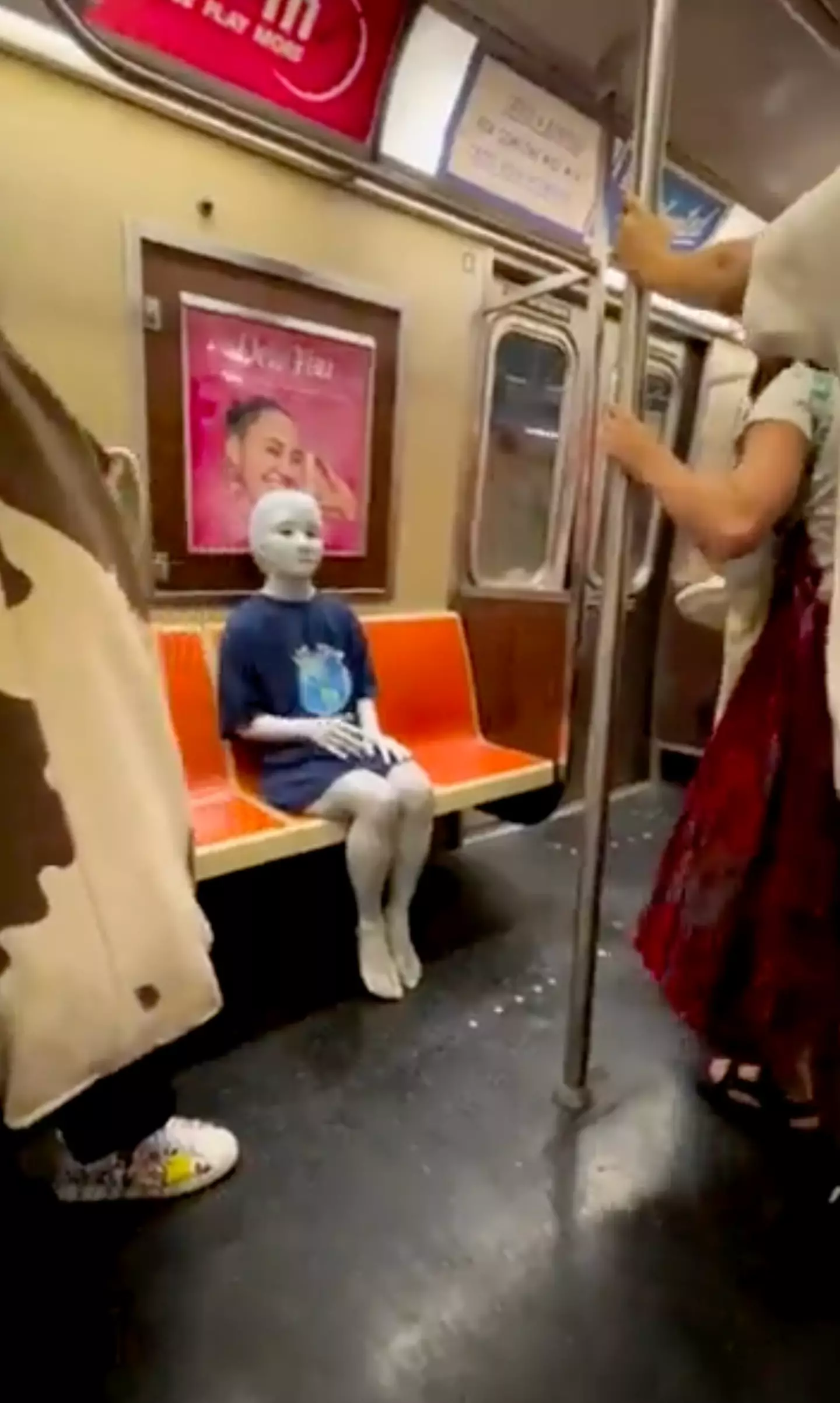 The alien was spotted quietly riding the subway.