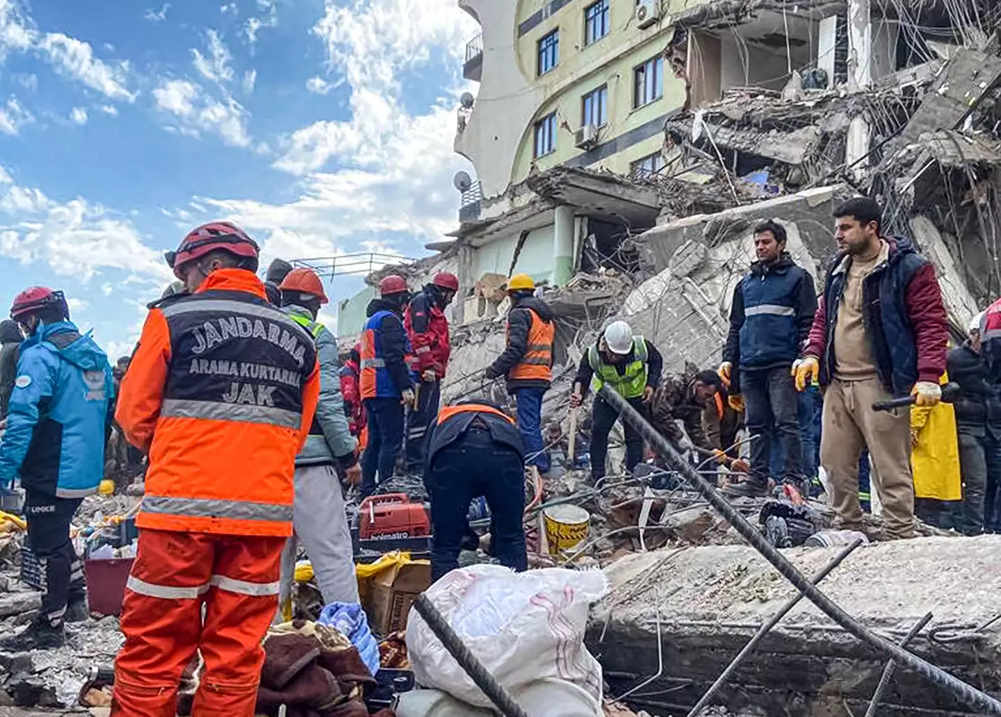 Rescue teams search for victims in the rubble on the second day following the earthquake.