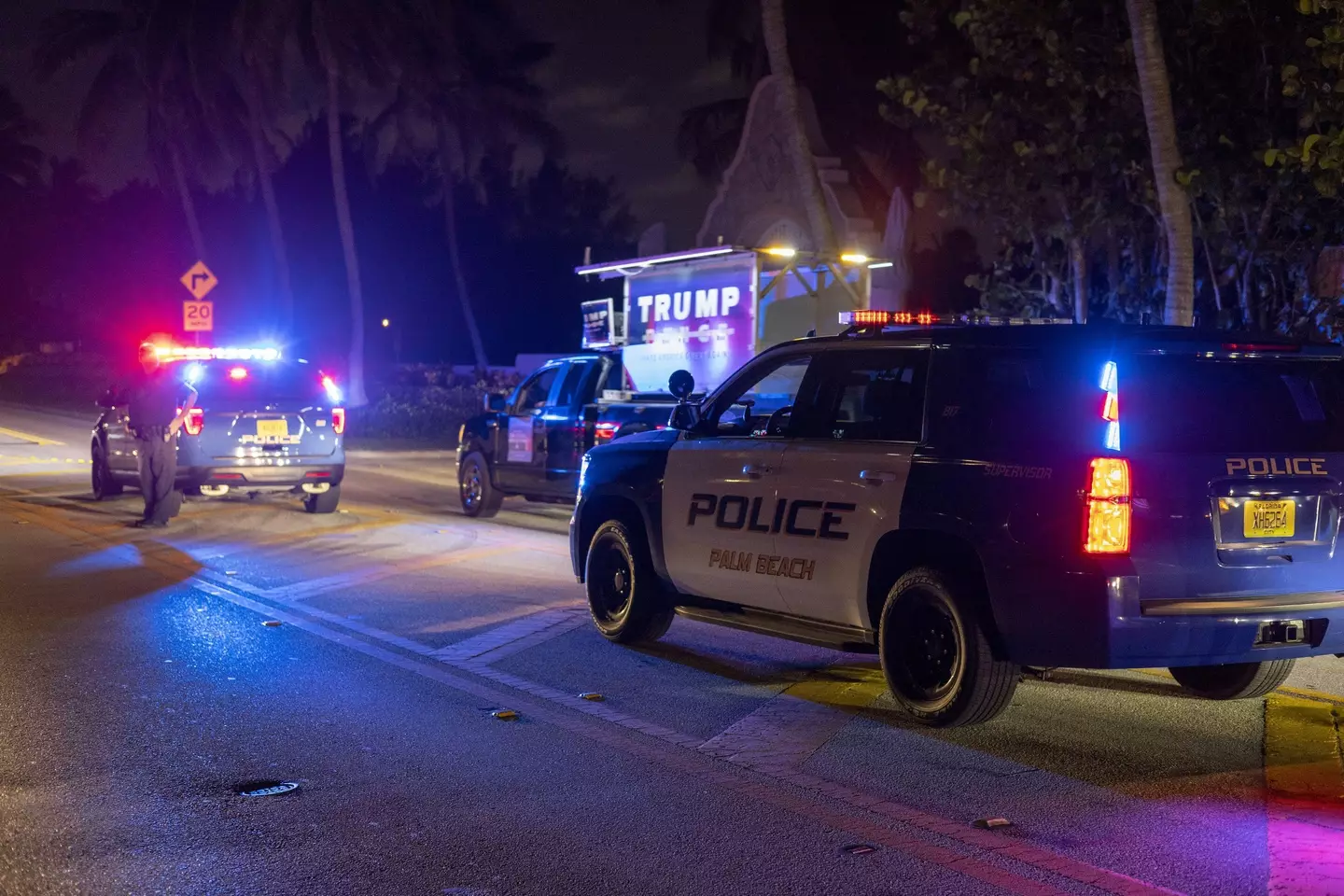 Police stand guard in front of the home of former President Donald Trump on Ocean Drive after the FBI executed a search warrant.