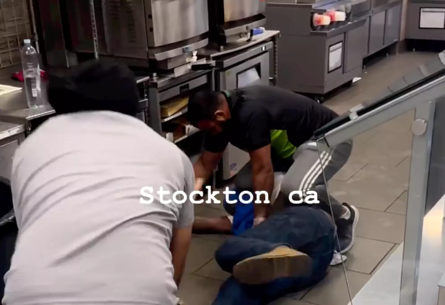 The employees began beating the robber with a stick.