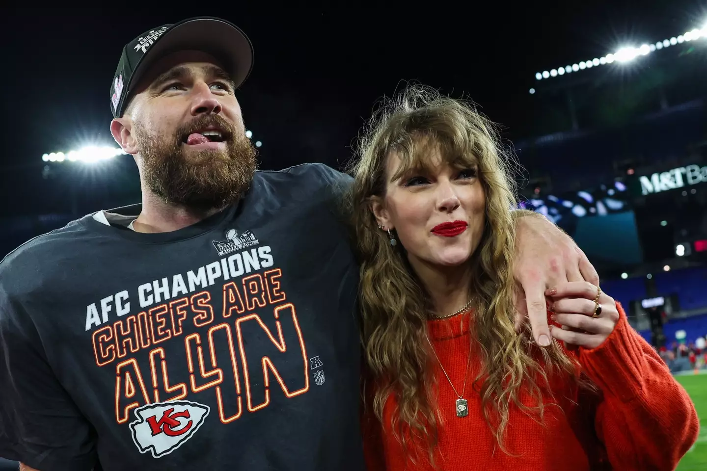 Taylor Swift celebrating with Travis Kelce on the pitch.