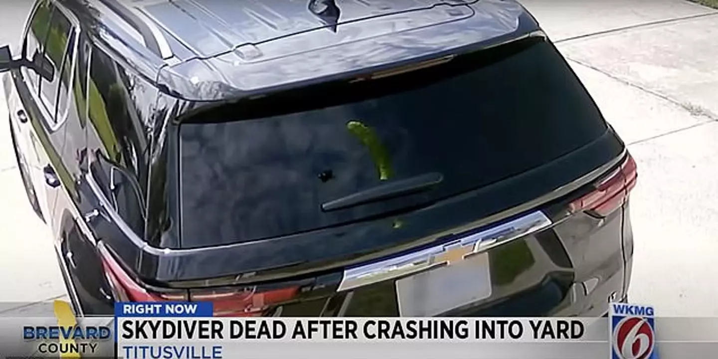 The skydiver is clearly visible in the reflection.