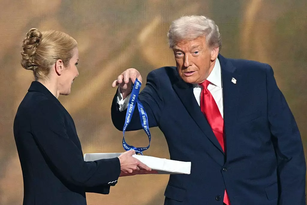 Donald Trump made a sarcastic gesture as he had to remove the medal himself (Photo by Jim WATSON / AFP via Getty Images)