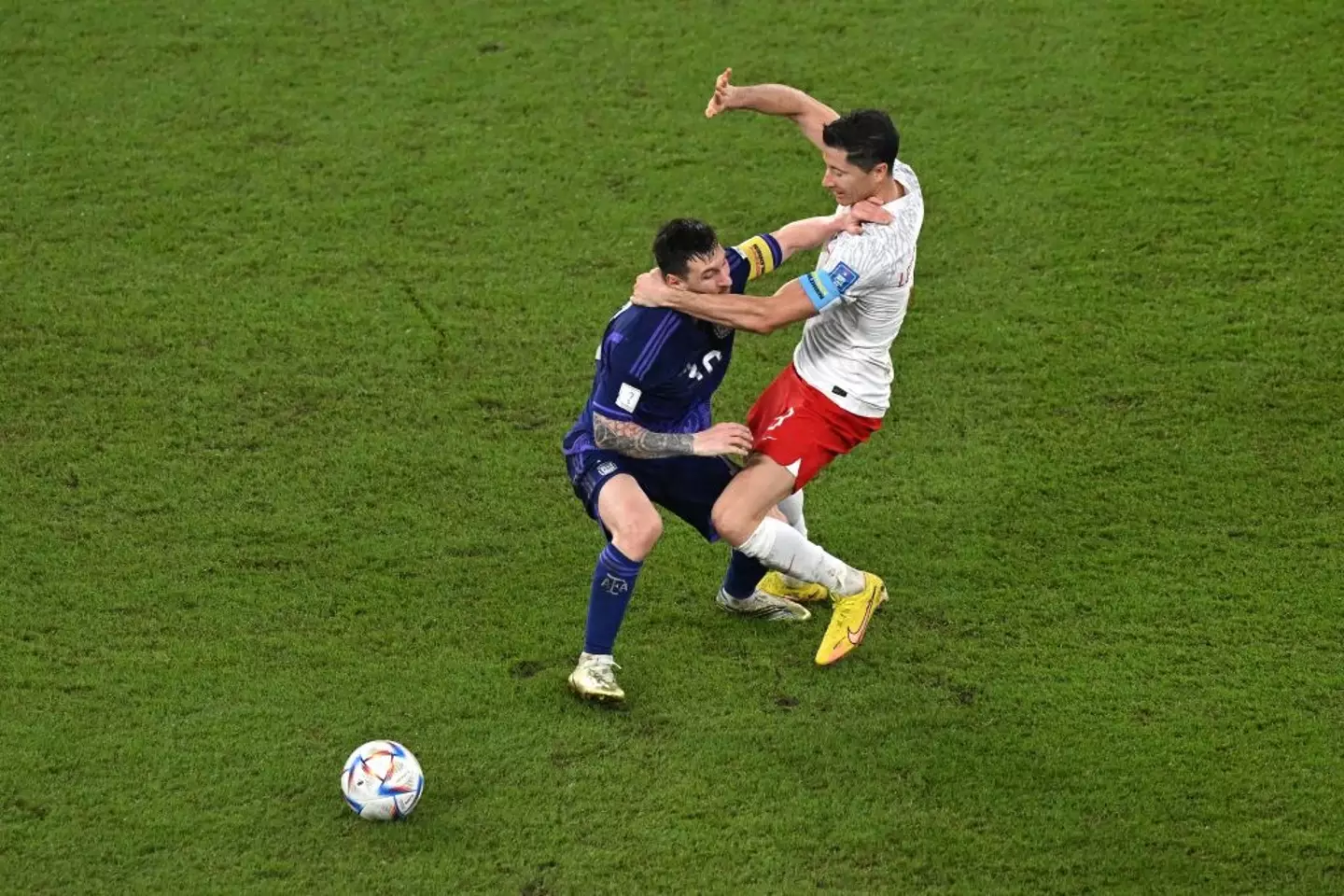 Lionel Messi and Robert Lewandowski jostle at the 2022 World Cup (Credit:Getty)