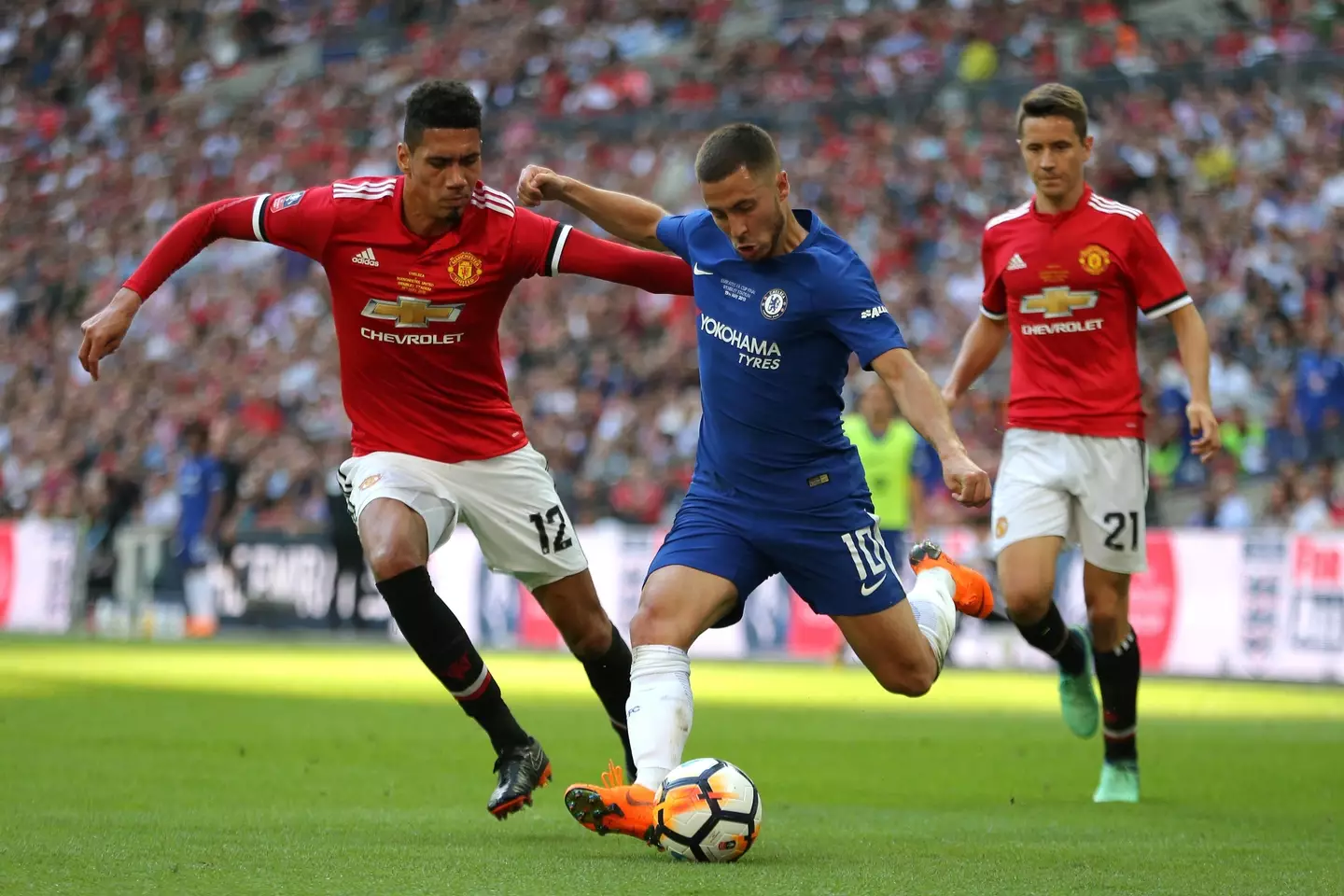 Smalling attempts to challenge Chelsea winger Eden Hazard. (Image