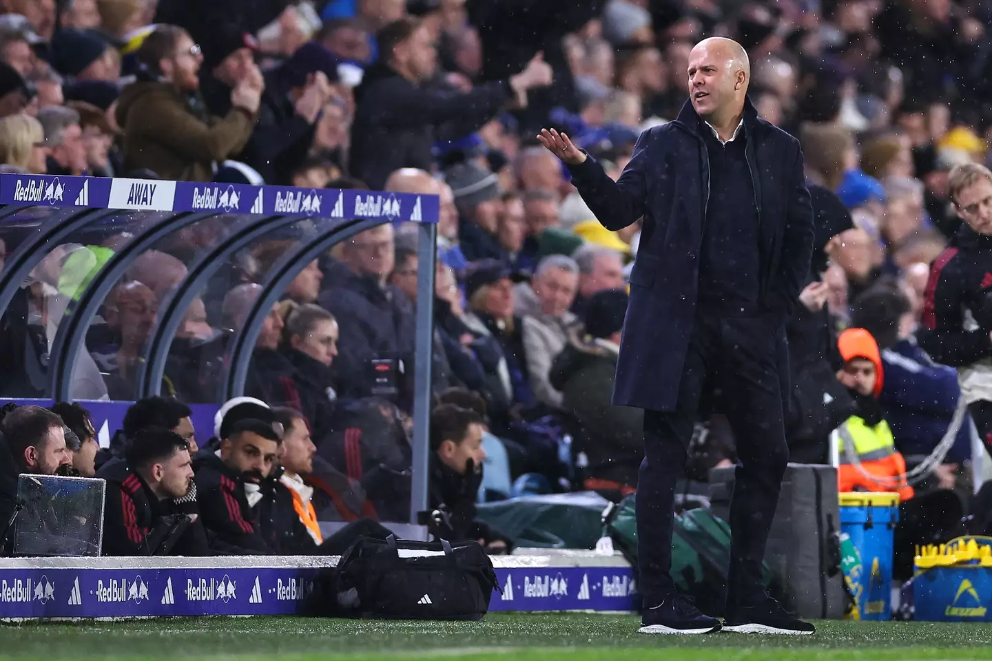 Arne Slot watches on at Leeds with Mo Salah on the bench (Image: Getty)