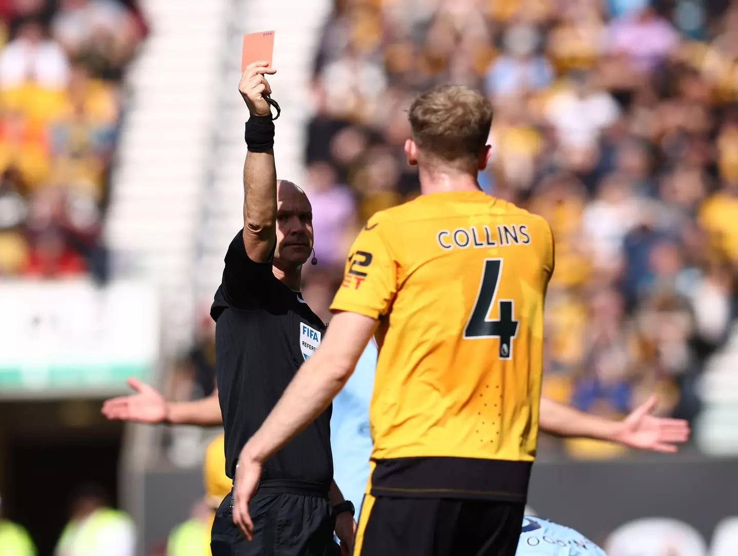 Nathan Collins of Wolverhampton Wanderers gets a red card from Anthony Taylor (Sportimage/Alamy)