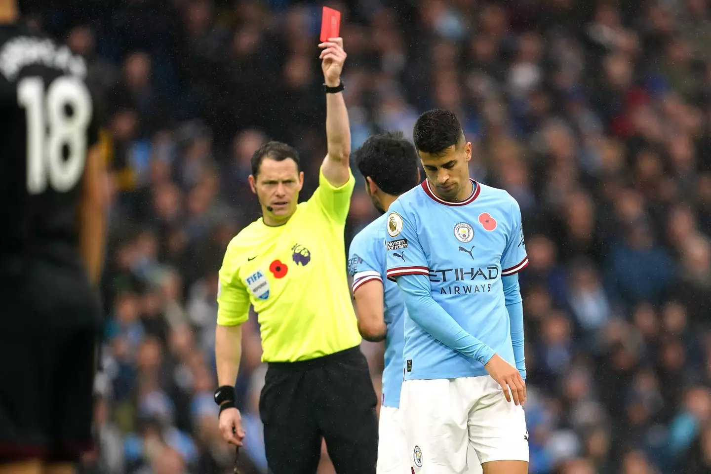 Referee Darren England shows a red card to Manchester City's Joao Cancelo (Image: PA Images/Alamy)