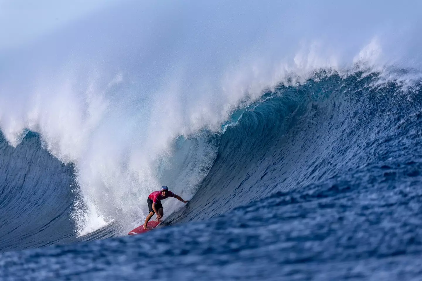 An Olympian rides a wave at Teahupo’o. Image: Getty