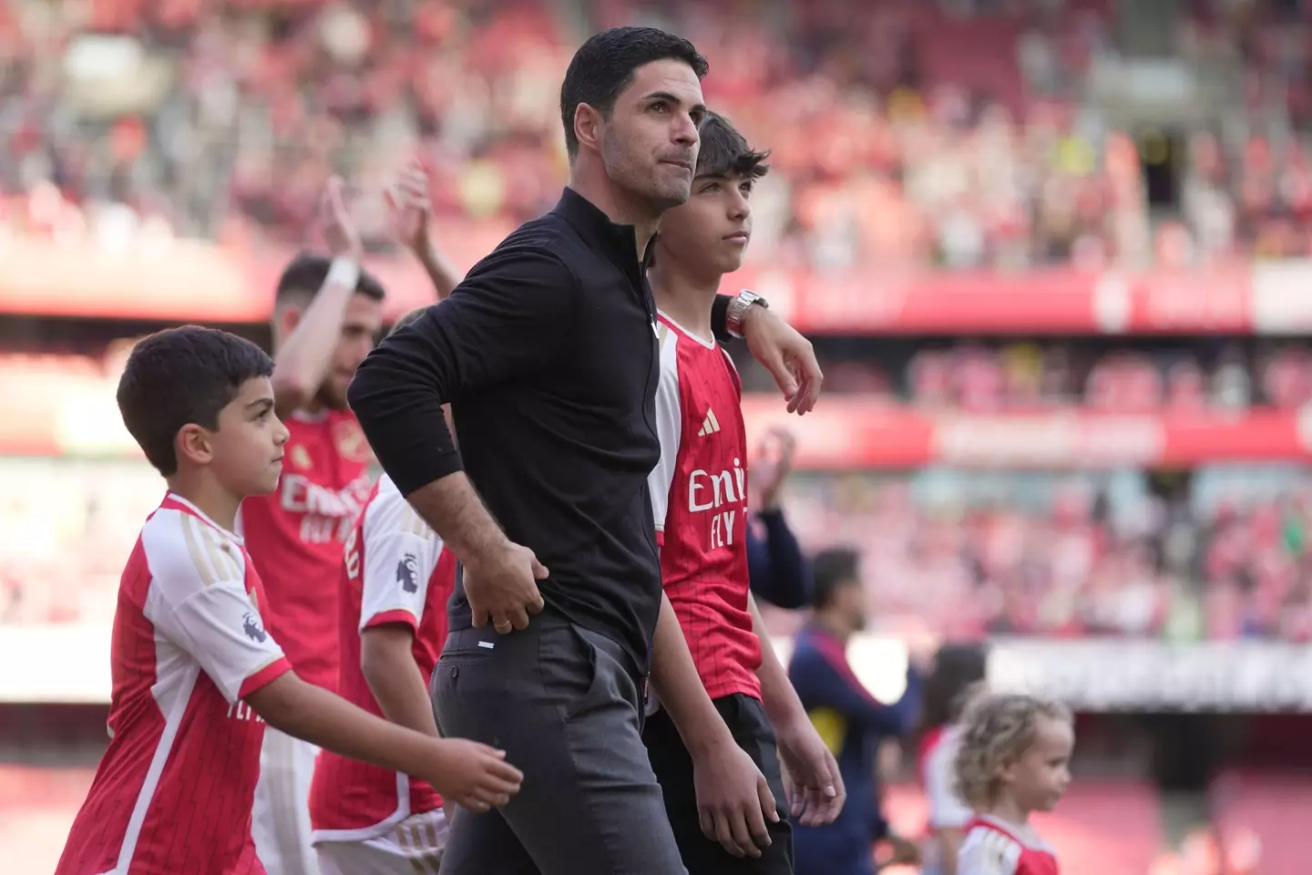 Mikel Arteta takes in the atmosphere with his sons. Image: Alamy