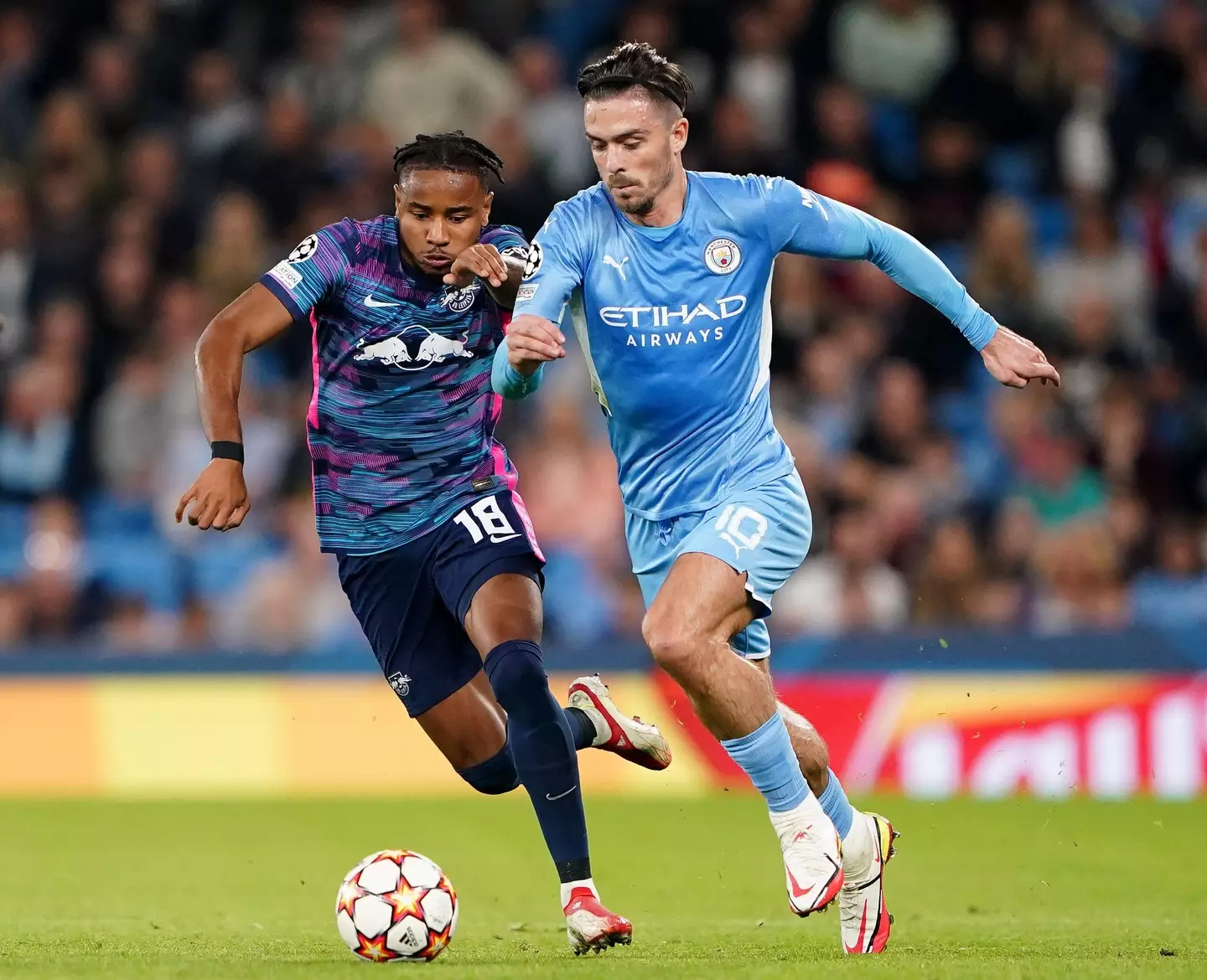 RB Leipzig's Christopher Nkunku (left) and Manchester City's Jack Grealish battle for the ball during the UEFA Champions League. (Alamy)