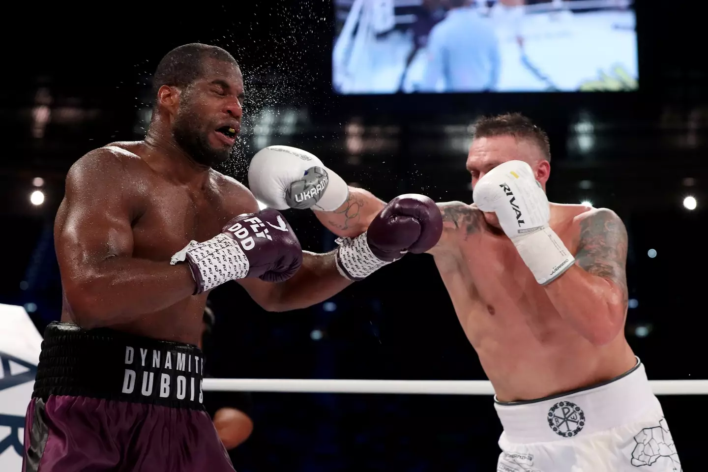 Oleksandr Usyk punches Daniel Dubois in their heavyweight title clash. (