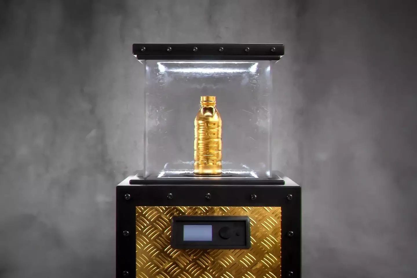 The golden PRIME bottle on display. (Image