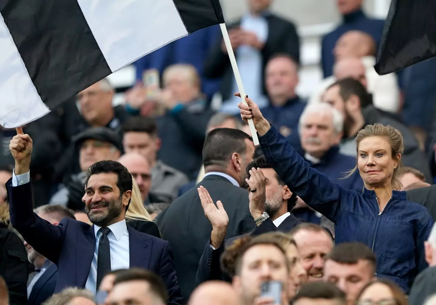Newcastle Chairman Yasir Al-Rumayyan and director Amanda Staveley waving flags. Image: Alamy