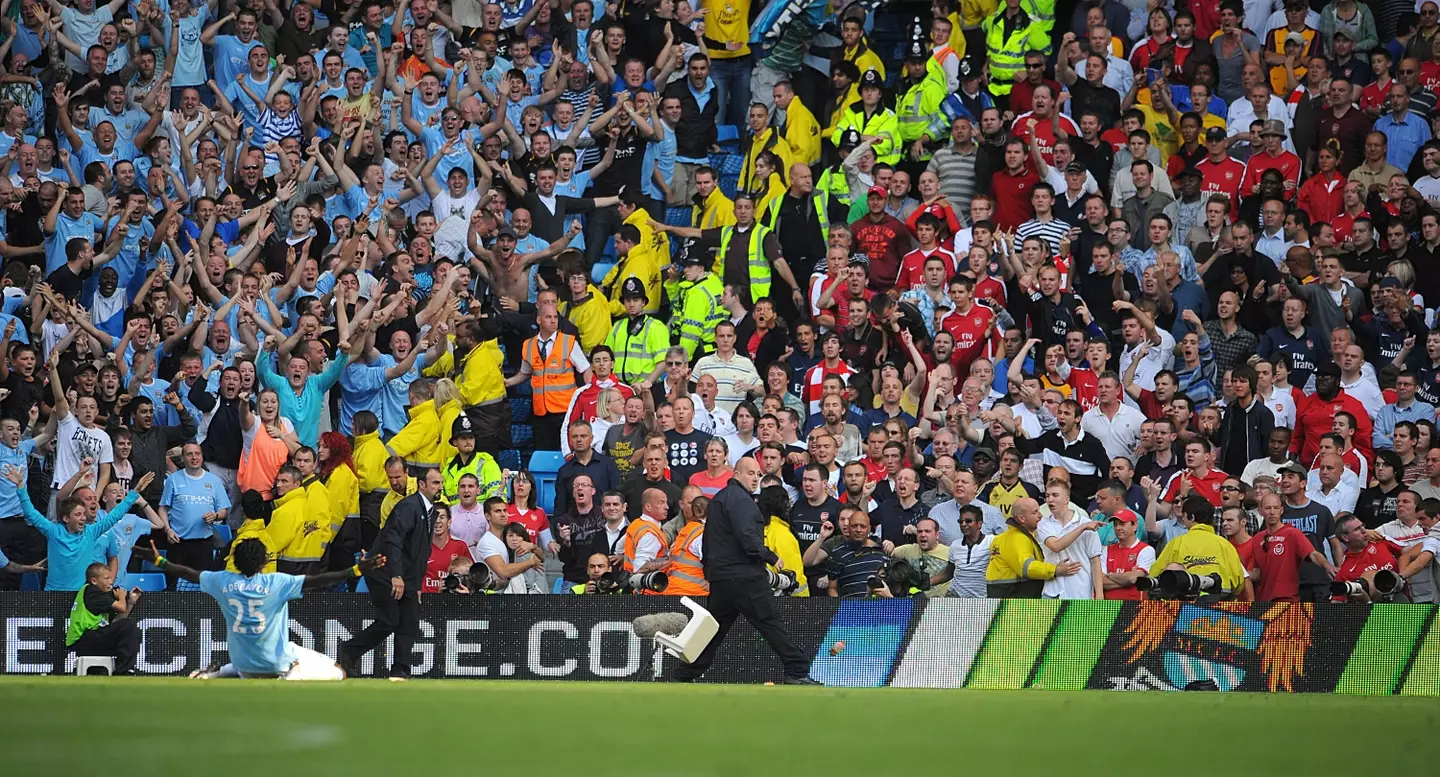 Adebayor celebrates in front of Arsenal fans. Image
