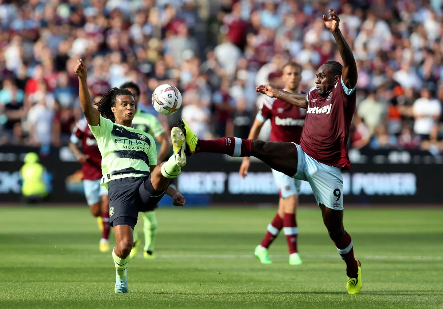 Nathan Ake challenges West Ham's Michail Antonio for the ball. (PA Images / Alamy)