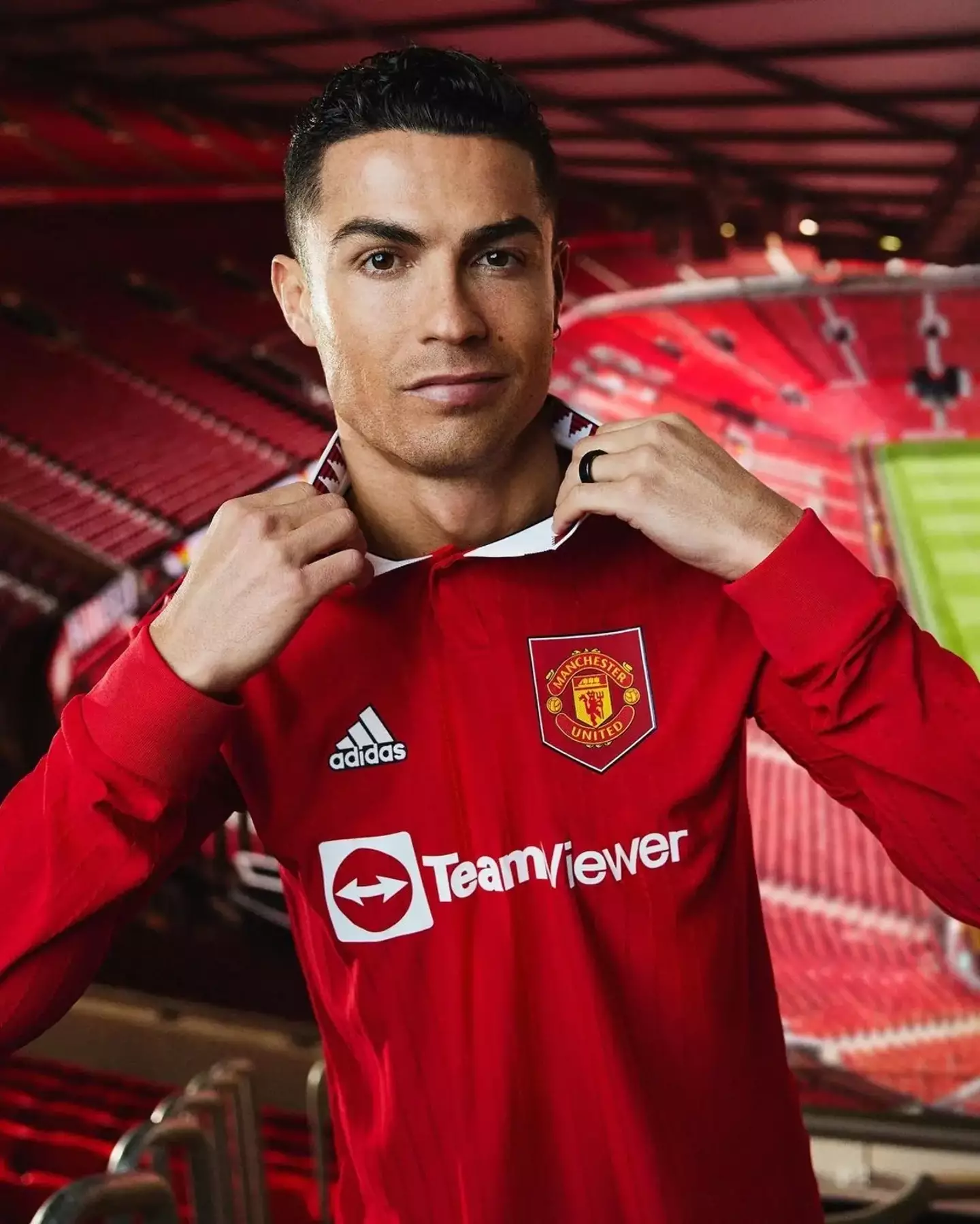 Ronaldo in the new kit, but it looks like he's trying to take it off. Image: Man United