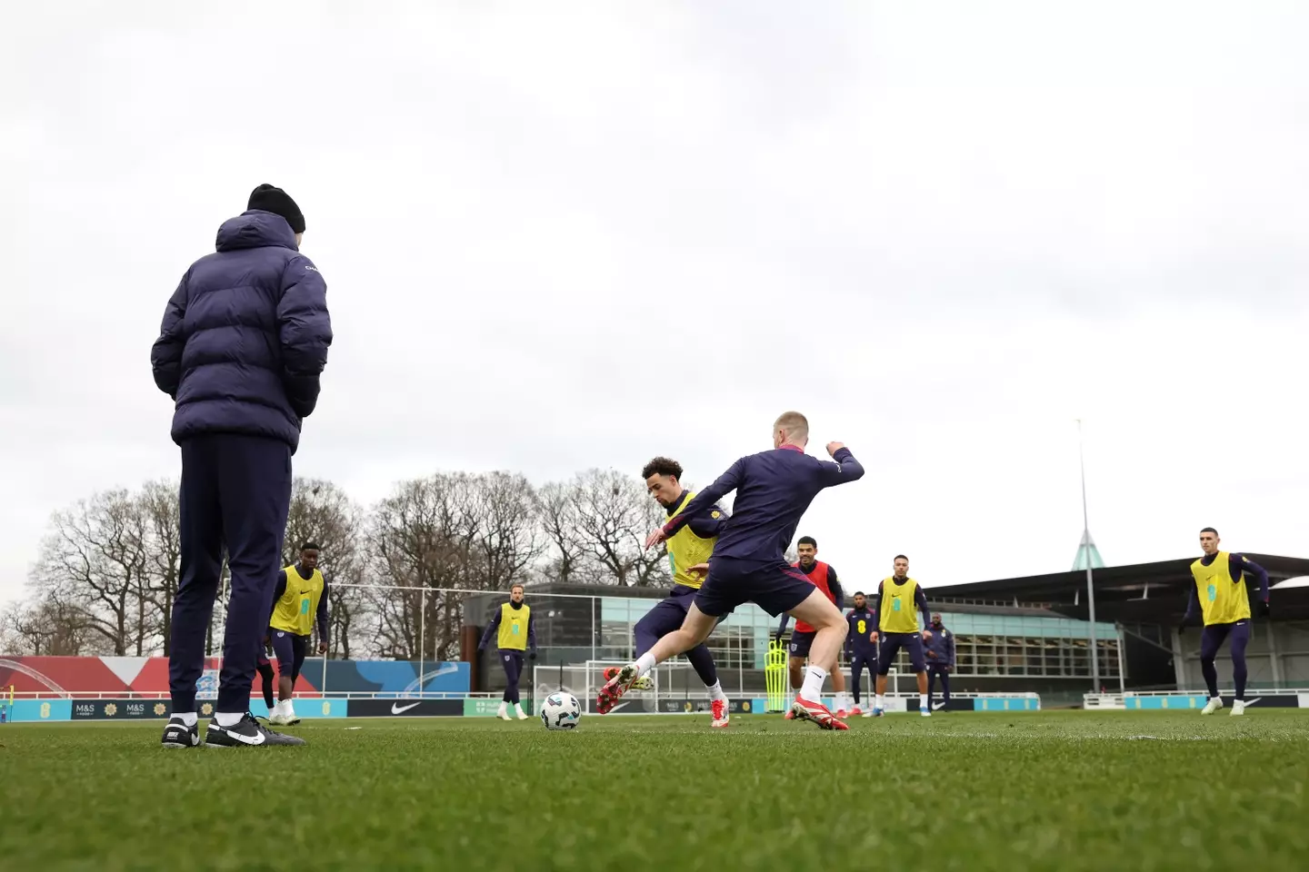 Thomas Tuchel looks on as Adam Wharton trains with the England squad back in March. Image credit: Getty