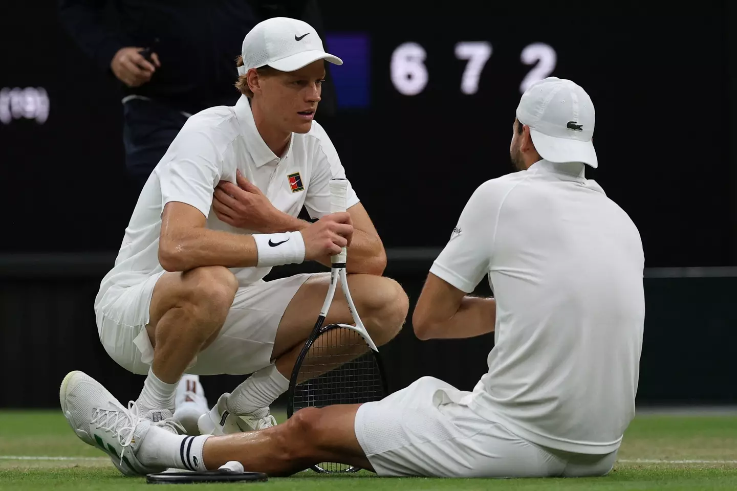 Jannik Sinner consoles Grigor Dimitrov after he suffers an injury. Image: Getty