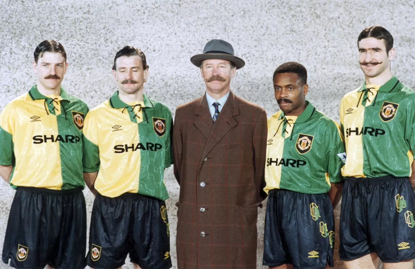 Sir Alex Ferguson alongside Lee Sharpe, Mark Hughes, Paul Parker and Eric Cantona sporting the green and gold kit while wearing fake moustaches. (Alamy)