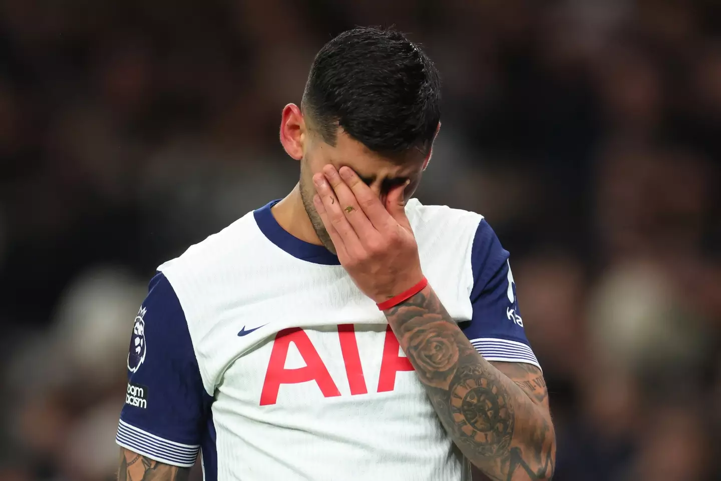 Cristian Romero cuts a dejected figure after limping off against Chelsea. Image: Getty