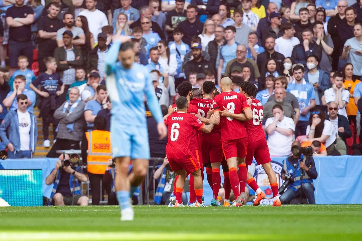 Liverpool players celebrate leaving City dejected. Image: PA Images