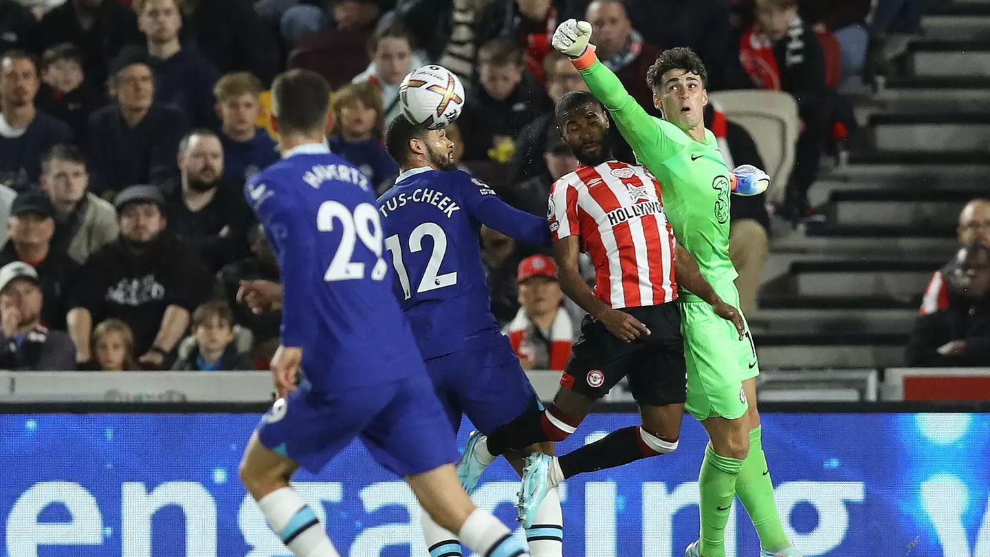 Kepa Arrizabalaga of Chelsea punches the ball clear ahead of Rico Henry of Brentford during the Premier League match. (Alamy)