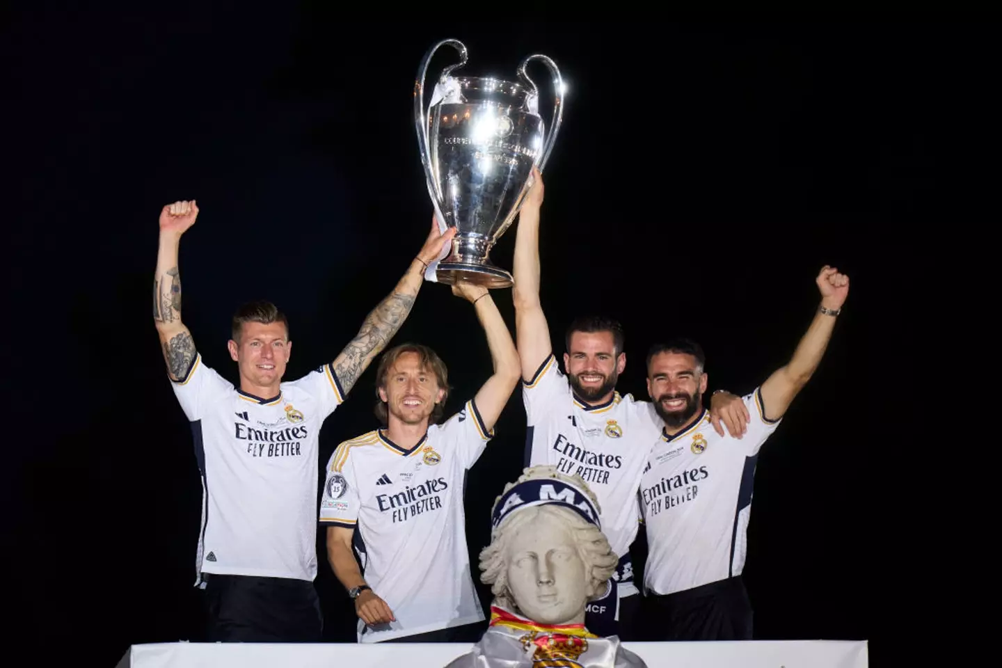 Toni Kroos celebrates with team-mates Luka Modric, Nacho Fernandez and Dani Carvajal during Real Madrid's 2024 Champions League trophy parade (