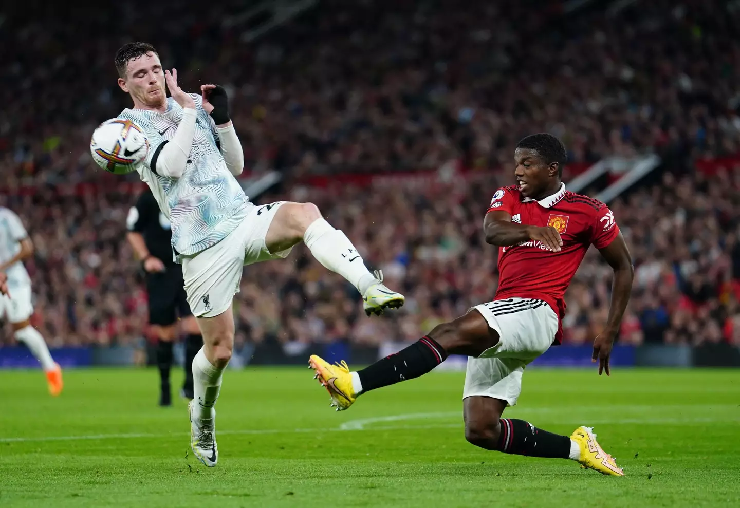 Tyrell Malacia challenges Andy Robertson. (Alamy)