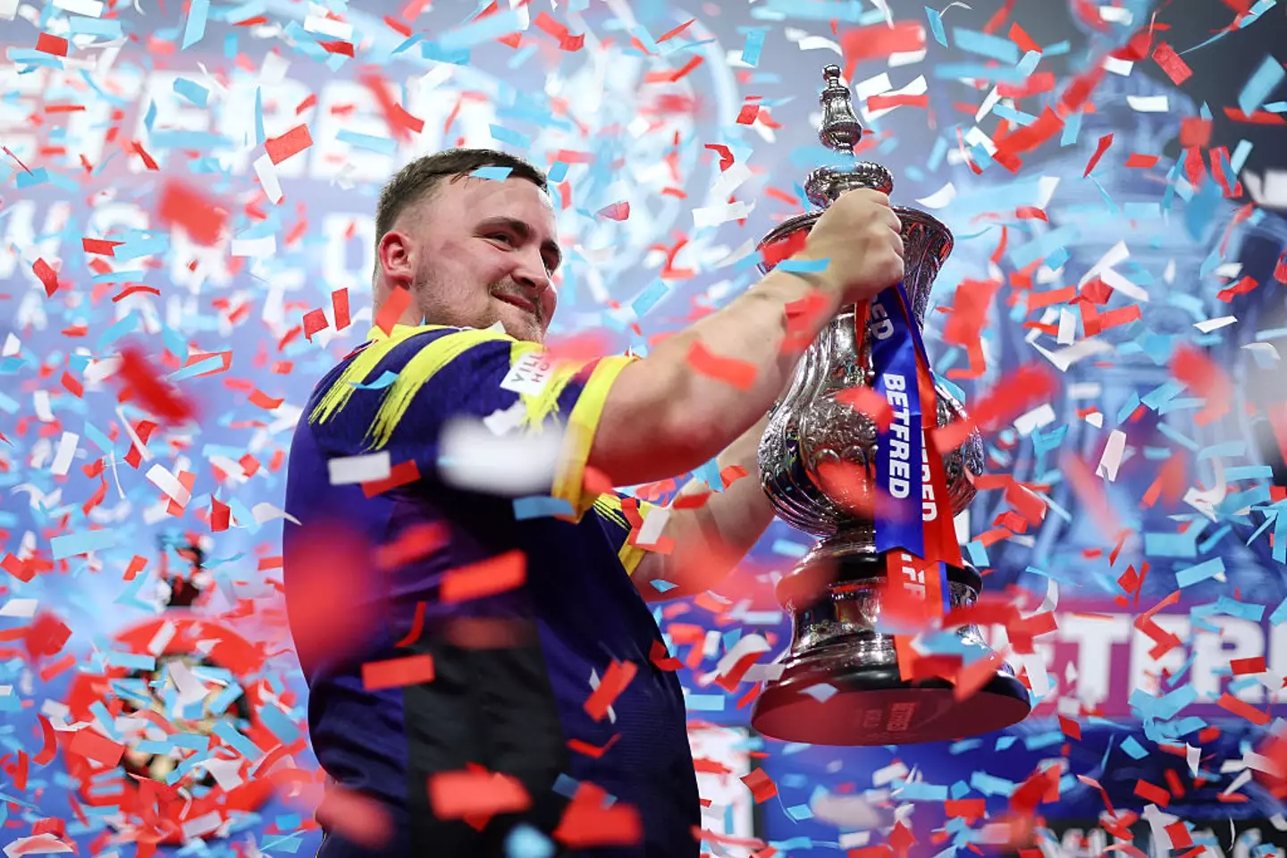 Luke Littler with the Phil Taylor Trophy (Credit:Getty)