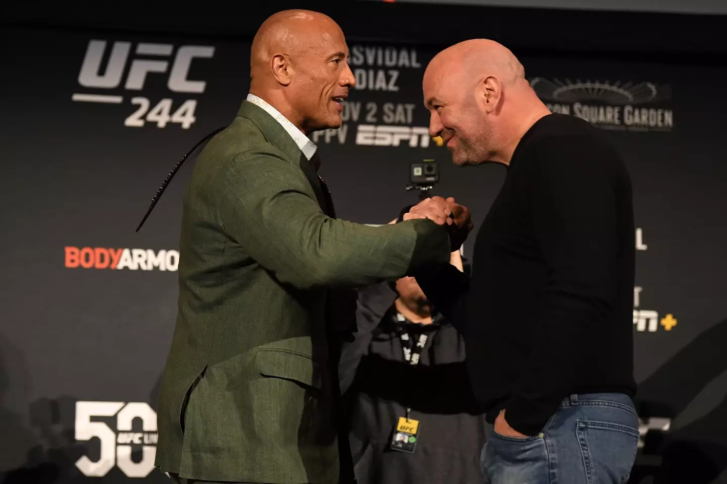 Dwayne Johnson and Dana White share an embrace at UFC 244. Image: Getty