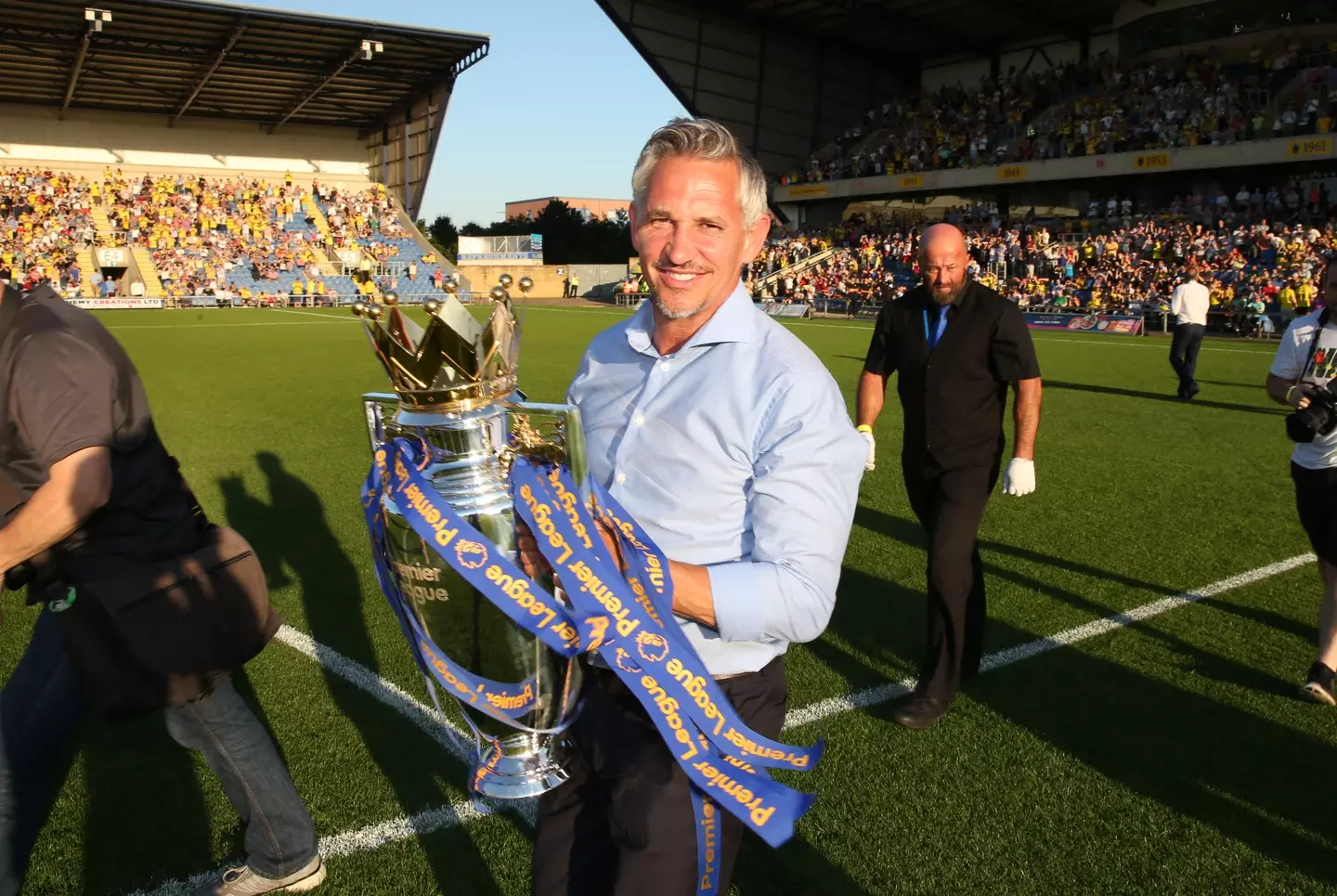 Lineker, a lifelong Leicester City fan, holding the Premier League title. (Image