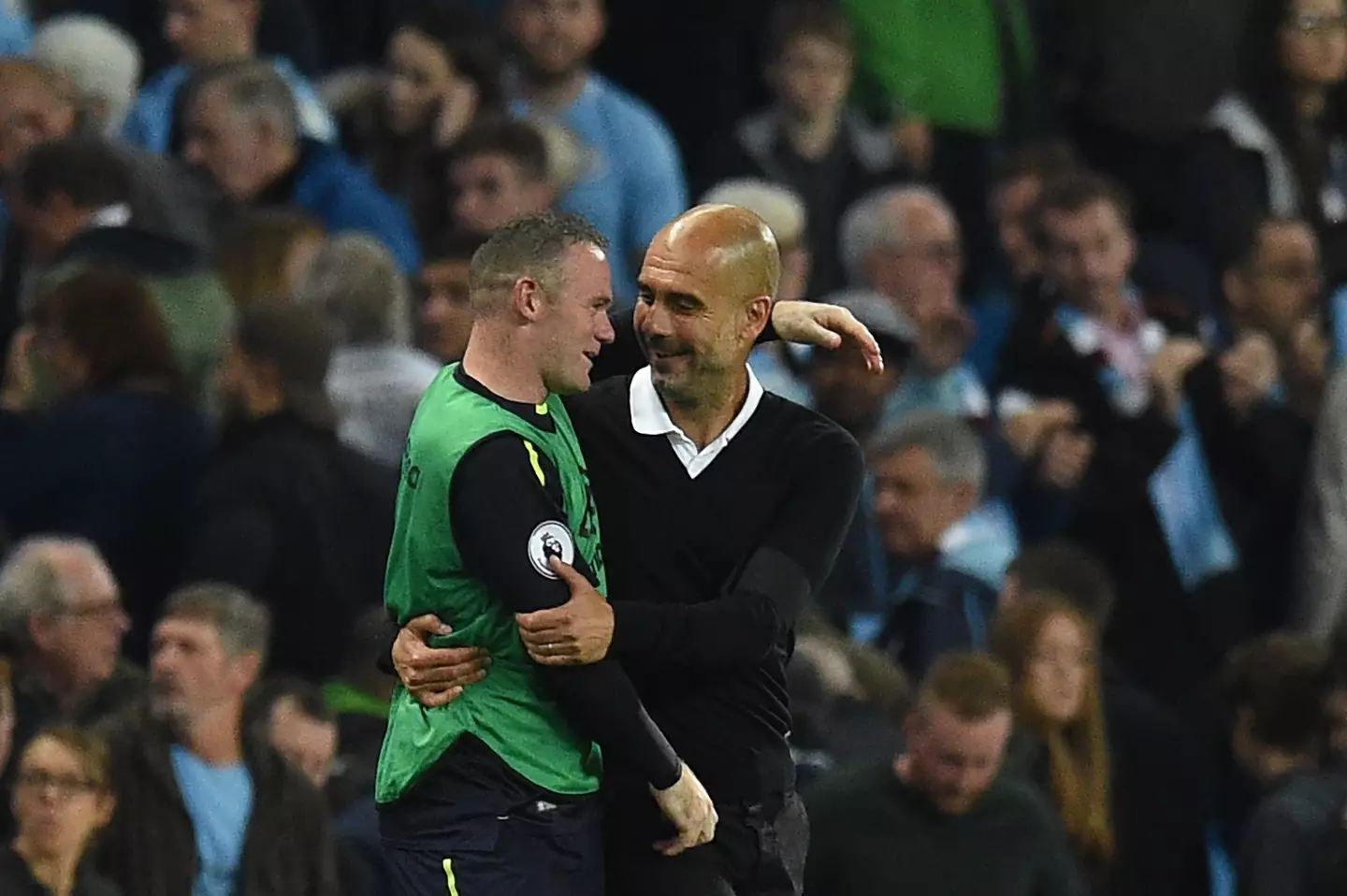 Wayne Rooney and Pep Guardiola share a warm embrace during a Premier League match between Manchester City and Everton. Image: Getty