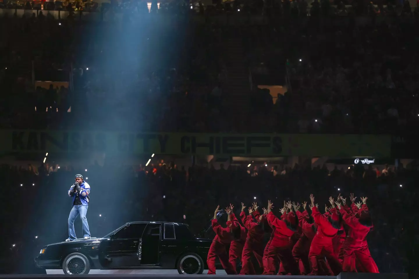 A section of Lamar's performance saw him stand on the hood of a car (Image: Getty)
