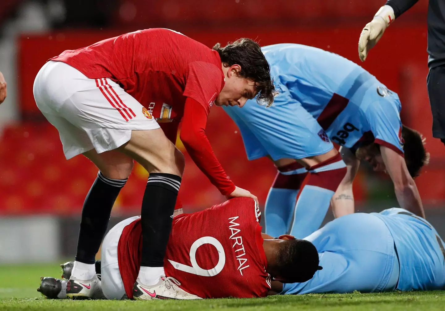 Martial on the ground, being comforted by Victor Lindelof. (Image