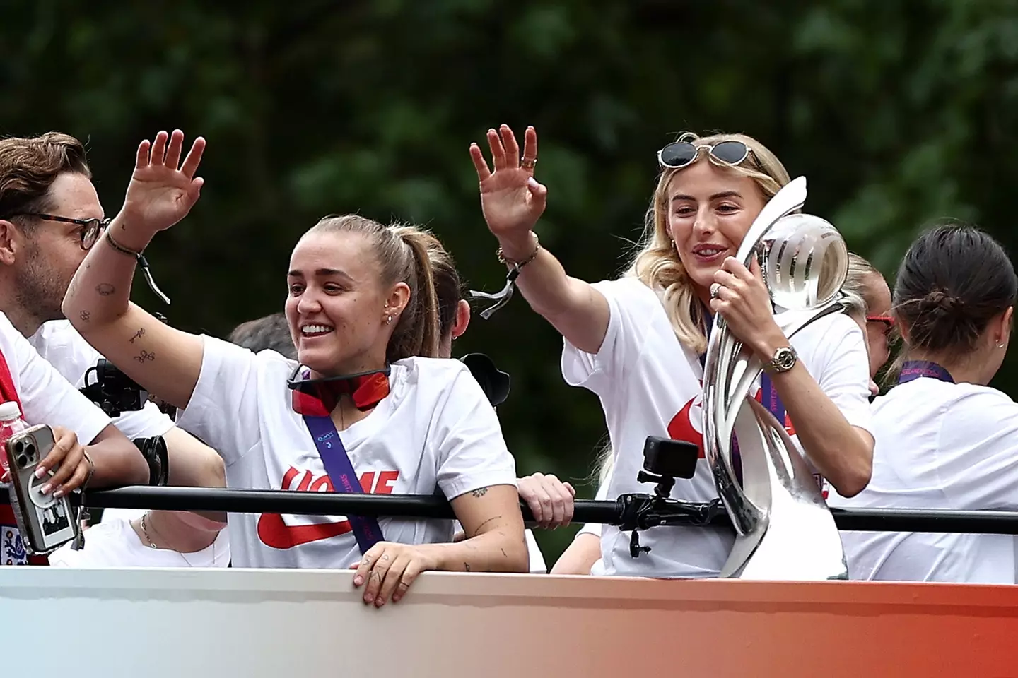 Chloe Kelly waves to fans during England's open-top bus parade. Image: Getty
