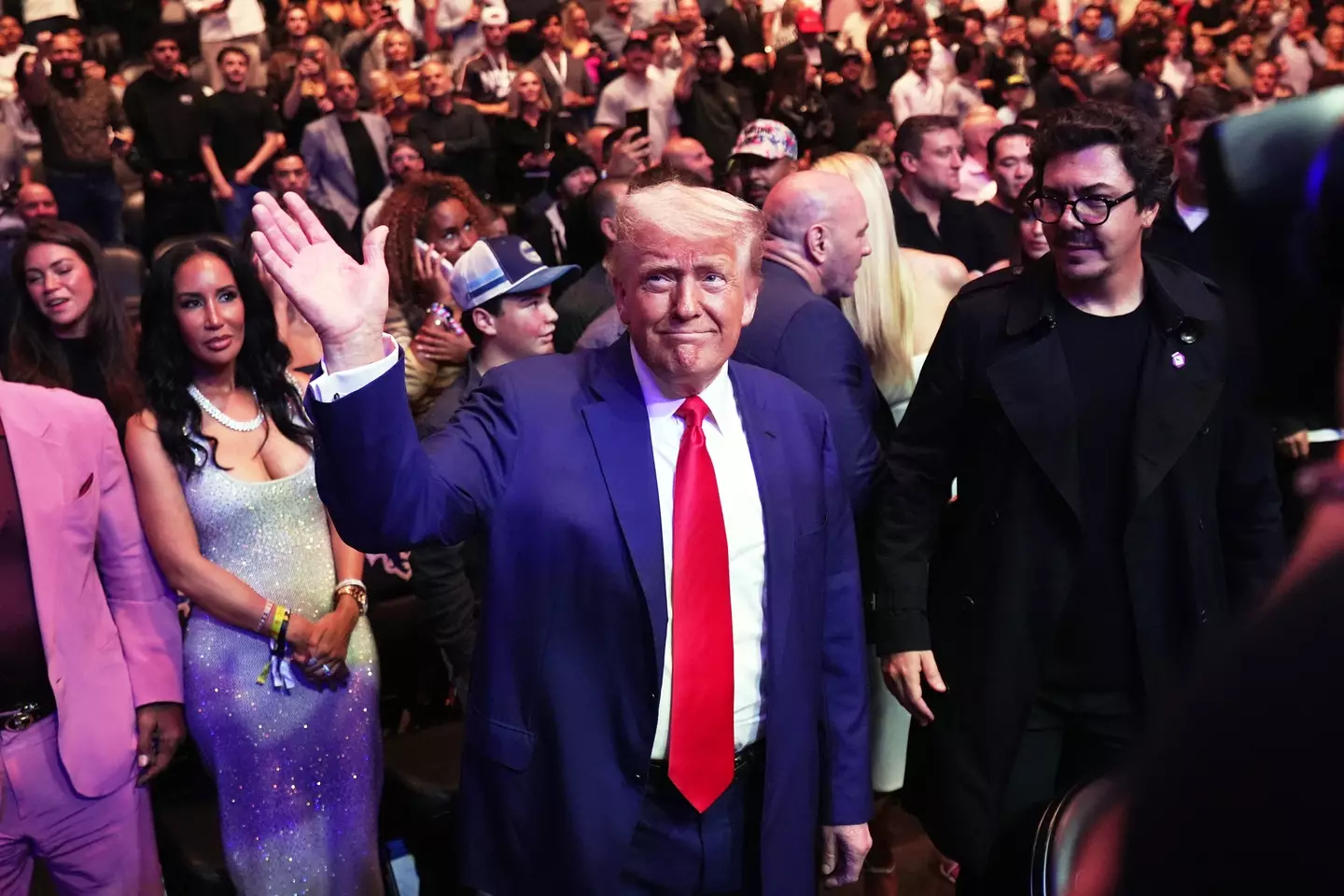 Donald Trump waves to the crowd at UFC 316. Image: Getty