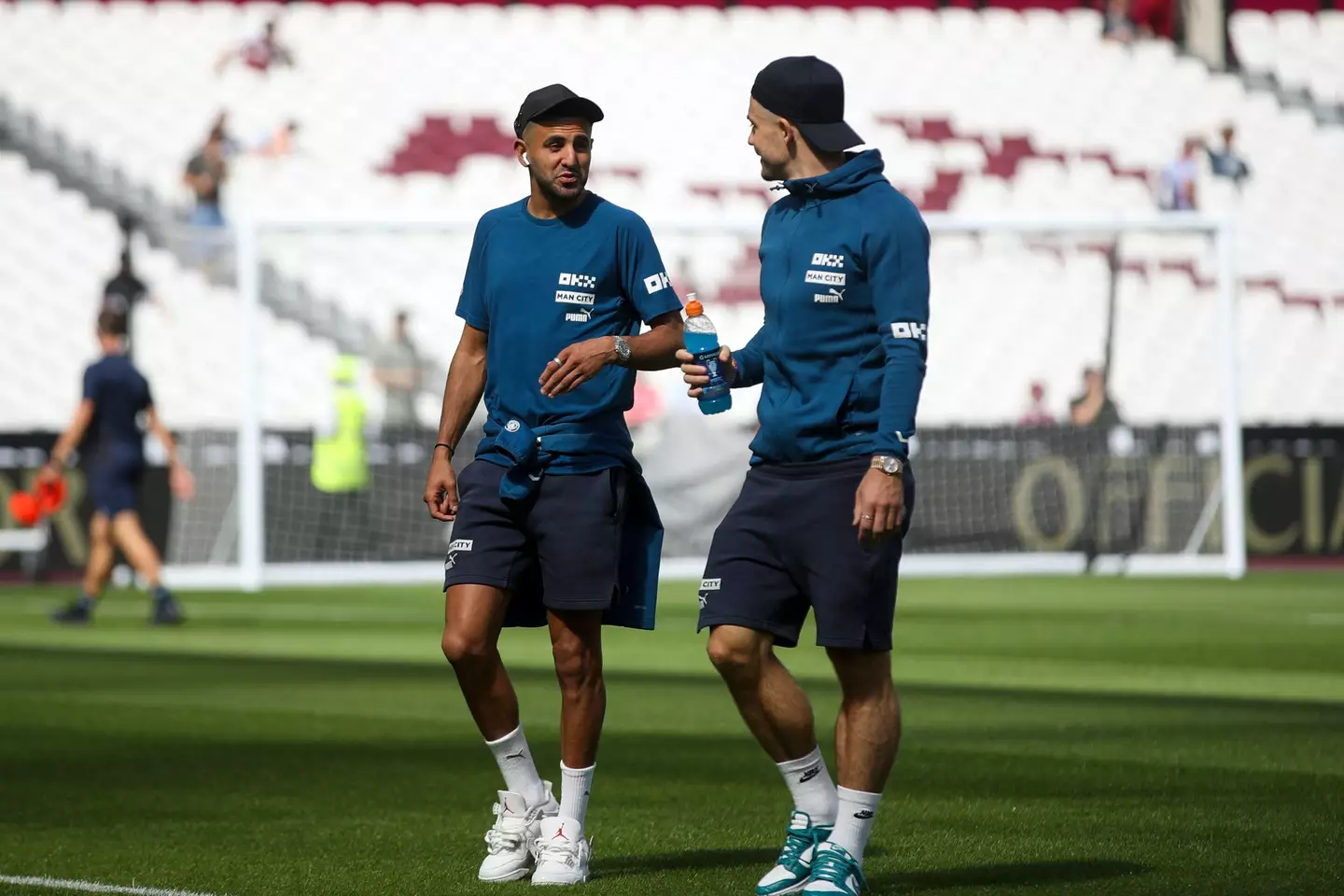 Manchester City's Jack Grealish in conversation with Riyad Mahrez at the London Stadium. (MI News & Sport / Alamy)