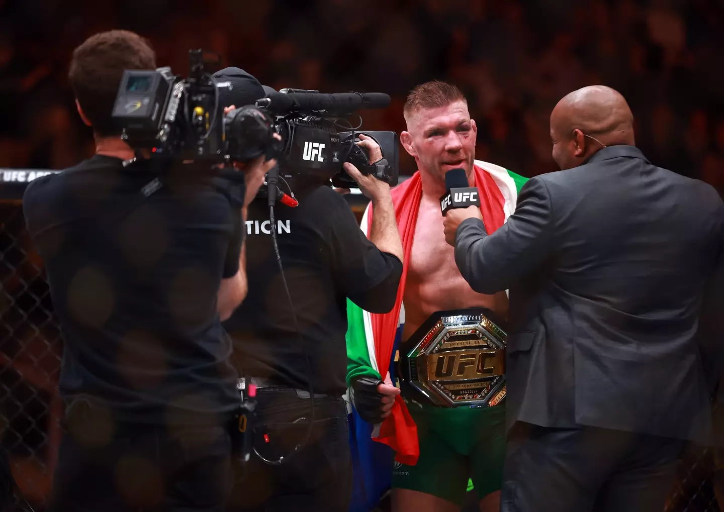 Dricus Du Plessis speaks to Daniel Cormier after beating Sean Strickland at UFC 297. Image: Getty