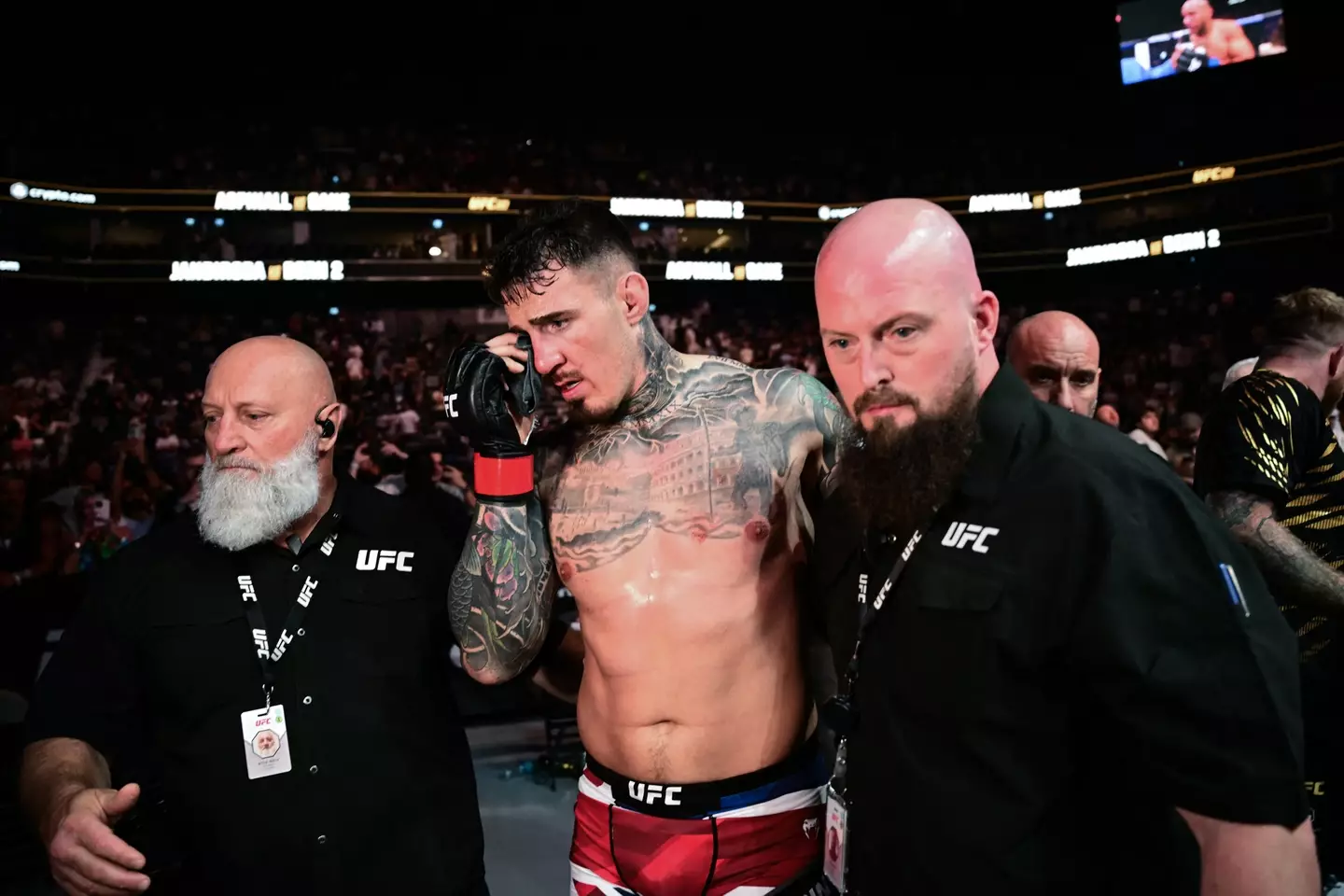 Aspinall clutches his eye after UFC 321. Image: Getty