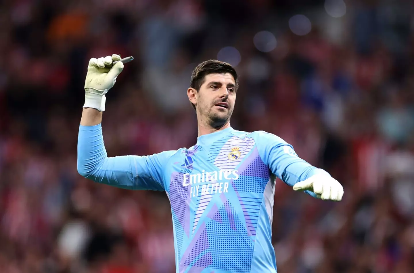 Various items including a lighter were thrown at Courtois during Real Madrid's fiery clash with Atletico Madrid. (Image: Getty)