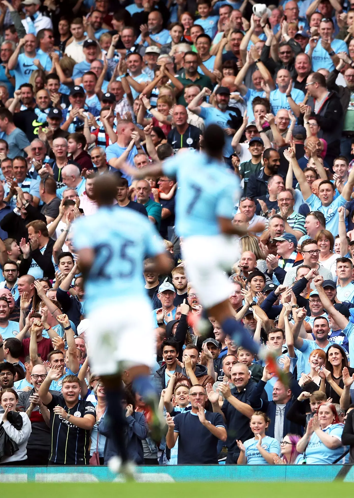 Manchester City's Raheem Sterling (right) celebrates scoring his side's first goal of the game with team-mate Luis Fernandinho in front of the fans. (Alamy)