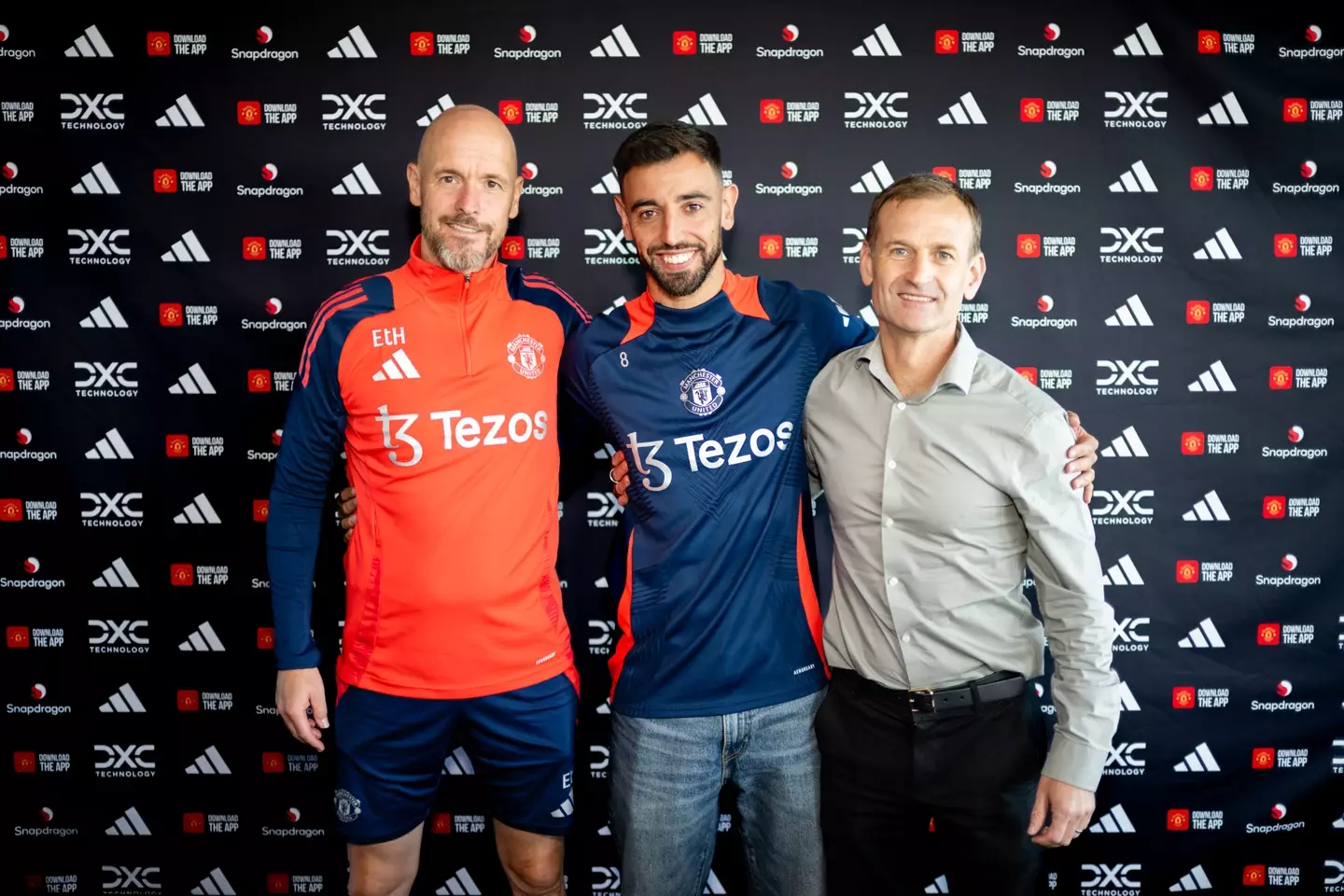 Bruno Fernandes poses with Erik ten Hag and Dan Ashworth after signing a contract extension. Image credit: Getty