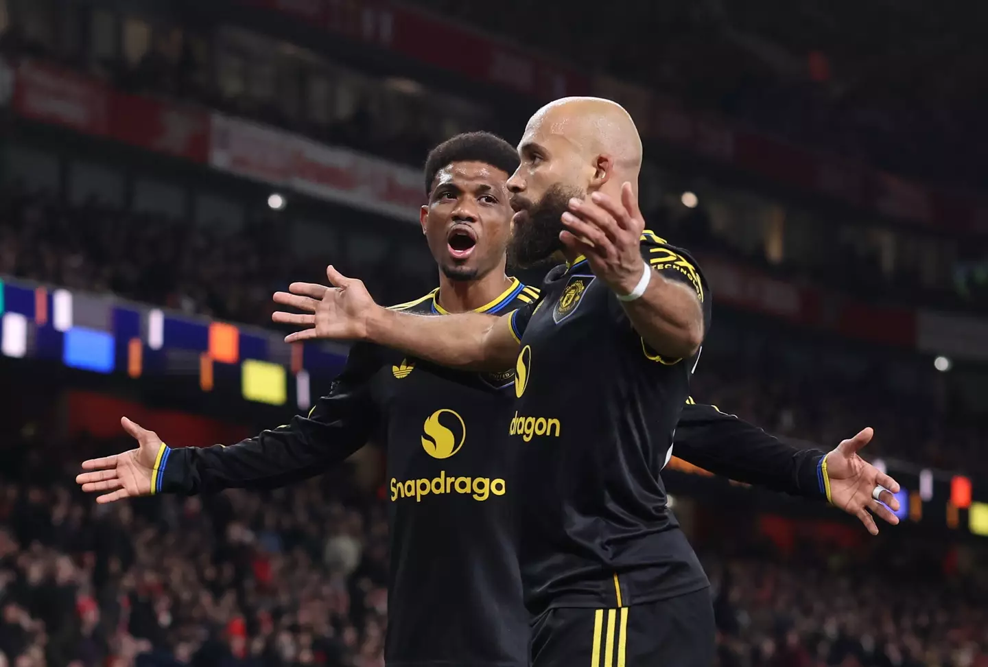 Amad celebrates with Mbeumo after he pulled United level. Image: Getty