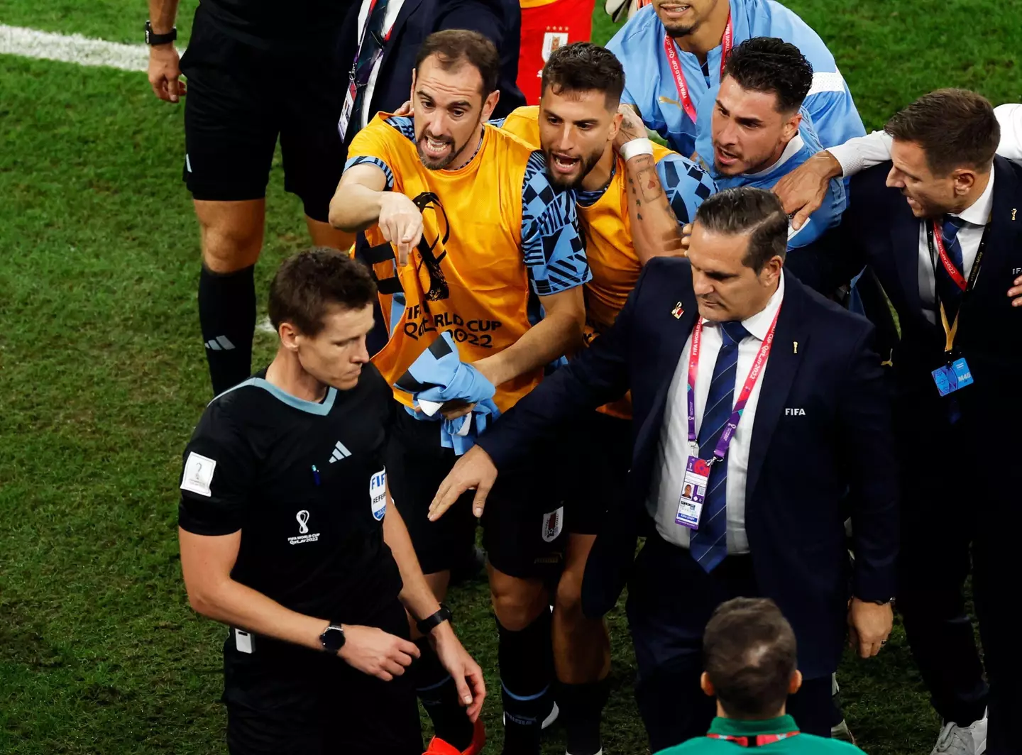 Godin and Rodrigo Bentancur remonstrate with the official. (Image