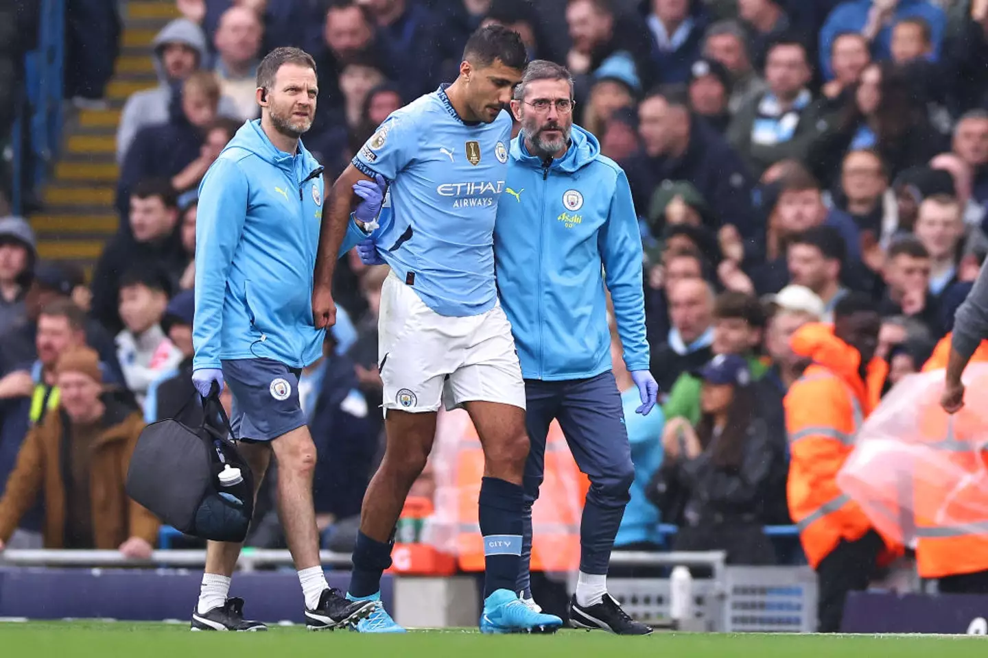 Rodri had to be helped off the pitch in the 22nd minute of City's clash with Arsenal. (Image: Getty)